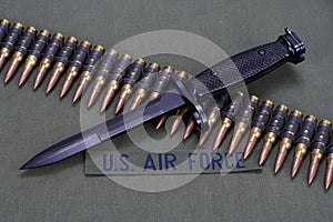 bayonet and ammunition belt on US AIR FORCE uniform background