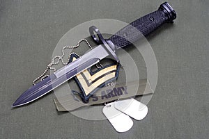 bayonet with dog tags on US ARMY uniform background