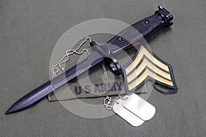 bayonet with dog tags on US ARMY uniform background