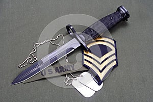 bayonet with dog tags on US ARMY uniform background