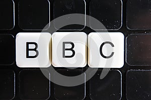 BBC text word crossword. Alphabet letter blocks game texture background. White alphabetical letters on black background