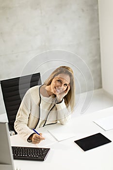 Bbeautiful businesswoman working on laptop in bright modern office