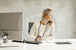 Bbeautiful businesswoman working on laptop in bright modern office