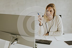 Bbeautiful businesswoman working on laptop in bright modern office