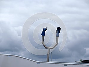 Bblue plastic gloves on metal contraption on fishing boat