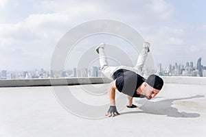 Bboy doing some stunts. Street artist breakdancing outdoors