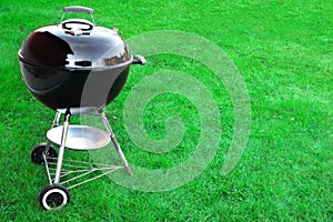 BBQ Charcoal Grill Appliance On The Lawn Background With Copy Sp