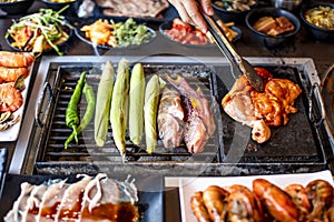 BBQ chicken and seefood  on grill at restaurant