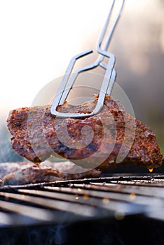 Bbq closeup with metal tongs photo