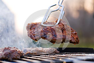 Bbq closeup with metal tongs photo