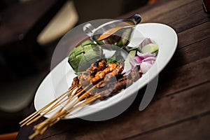 BBQ cooked skewers of chicken and beef with satay sauce