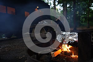 a bbq covered in foil sitting on top of an open fire