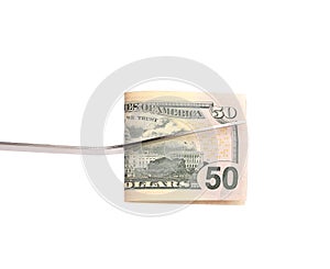 BBQ fork holds fifty dollar bill.