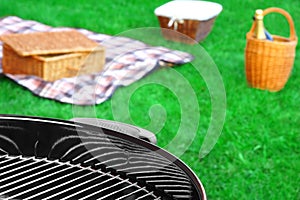 BBQ Grill,Picnic Basket With Wine, Blanket On The Lawn