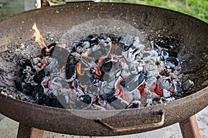 BBQ Grill Pit Glowing And Flaming Hot Charcoal Briquettes coal Food Background Or Texture Close-Up Top View