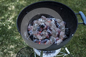 BBQ Grill Pit Glowing And Flaming Hot Charcoal Briquettes coal Food Background Or Texture Close-Up Top View