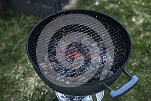 BBQ Grill Pit Glowing And Flaming Hot Charcoal Briquettes coal Food Background Or Texture Close-Up Top View