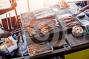 BBQ grill seafood on boat at Amphawa river market