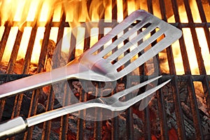 BBQ Grill Tools On The Hot Flaming Cast Iron Grate