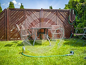 BBQ grillage rost and hose lying on the wet lawn photo