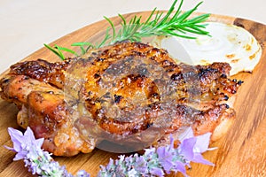 Bbq grilled boneless chicken thigh with onion slice and with rosemary and lavender garnish photo