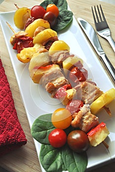 BBQ grilled chicken vegetable kebab skewers ready to eat served on a plate