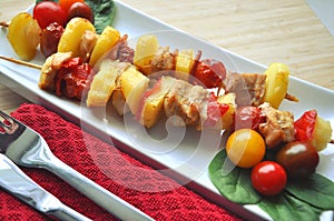 BBQ grilled chicken vegetable kebab skewers ready to eat served on a plate
