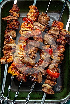 Bbq grilled meat pork, chicken and vegetable skewers on tray. Top view, flat lay