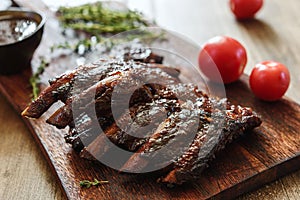 BBQ grilled pork ribs in Barbecue sauce on vintage wooden table