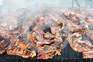 BBQ meat roasted on hot flaming charcoal grill