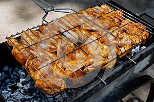 BBQ picnic time Roasted chicken legs and wings on grill. Grilling meat on outdoor grill grid tasty barbeque chicken