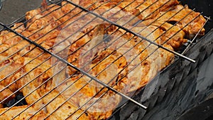 BBQ picnic time Roasted chicken legs and wings on grill. Grilling meat on outdoor grill grid tasty barbeque chicken