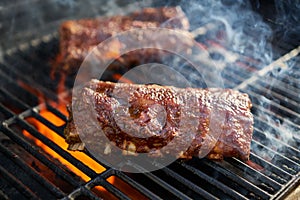 Bbq pork ribs cooking on flaming grill