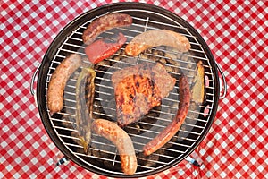 BBQ Portable Grill With Assorted Meat And Picnic Red Blanket