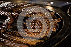 BBQ Roast Marinated Baby Back Pork Ribs. Close-up On Hot Flaming Grill Background