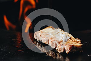 BBQ Roast Marinated Baby Back Pork Ribs Close-up On Hot Flaming Grill Background