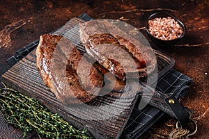 BBQ roasted Shoulder Top Blade cut or Australia wagyu oyster blade beef steak. Dark background. Top View