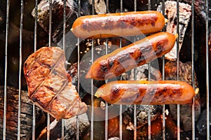 BBQ sausages and meat on the grill.