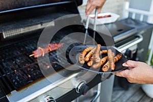 BBQ with sausages and red meat on the grill photo