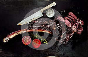 BBQ tomahawk steak sliced through photo