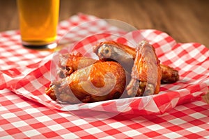 bbw wings served on a red and white checkered napkin