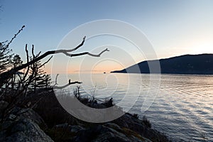 BC Ferry boat travelling through Howe Sound at sunset as seen from Whytecliff park