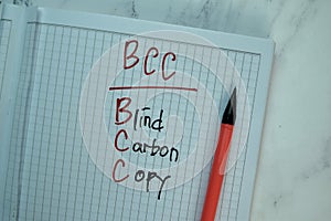 BCC - Blind Carbon Copy write on a book isolated on Wooden Table photo