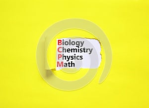 BCPM biology chemistry physics math symbol. Concept words BCPM biology chemistry physics math on white paper on beautiful yellow