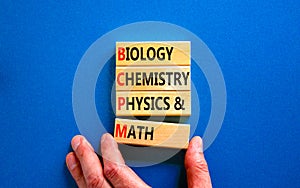 BCPM biology chemistry physics math symbol. Concept words BCPM biology chemistry physics math on wooden blocks on beautiful blue