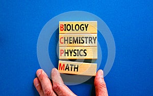 BCPM biology chemistry physics math symbol. Concept words BCPM biology chemistry physics math on wooden blocks on beautiful blue