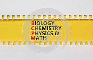 BCPM biology chemistry physics math symbol. Concept words BCPM biology chemistry physics math on yellow paper on beautiful white