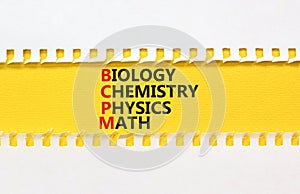 BCPM biology chemistry physics math symbol. Concept words BCPM biology chemistry physics math on yellow paper on beautiful white