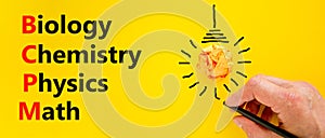 BCPM biology chemistry physics math symbol. Concept words BCPM biology chemistry physics math on yellow paper on beautiful yellow