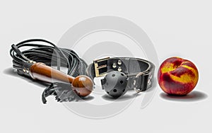 bdsm leather black gag whip and ripe peach fruit on white background